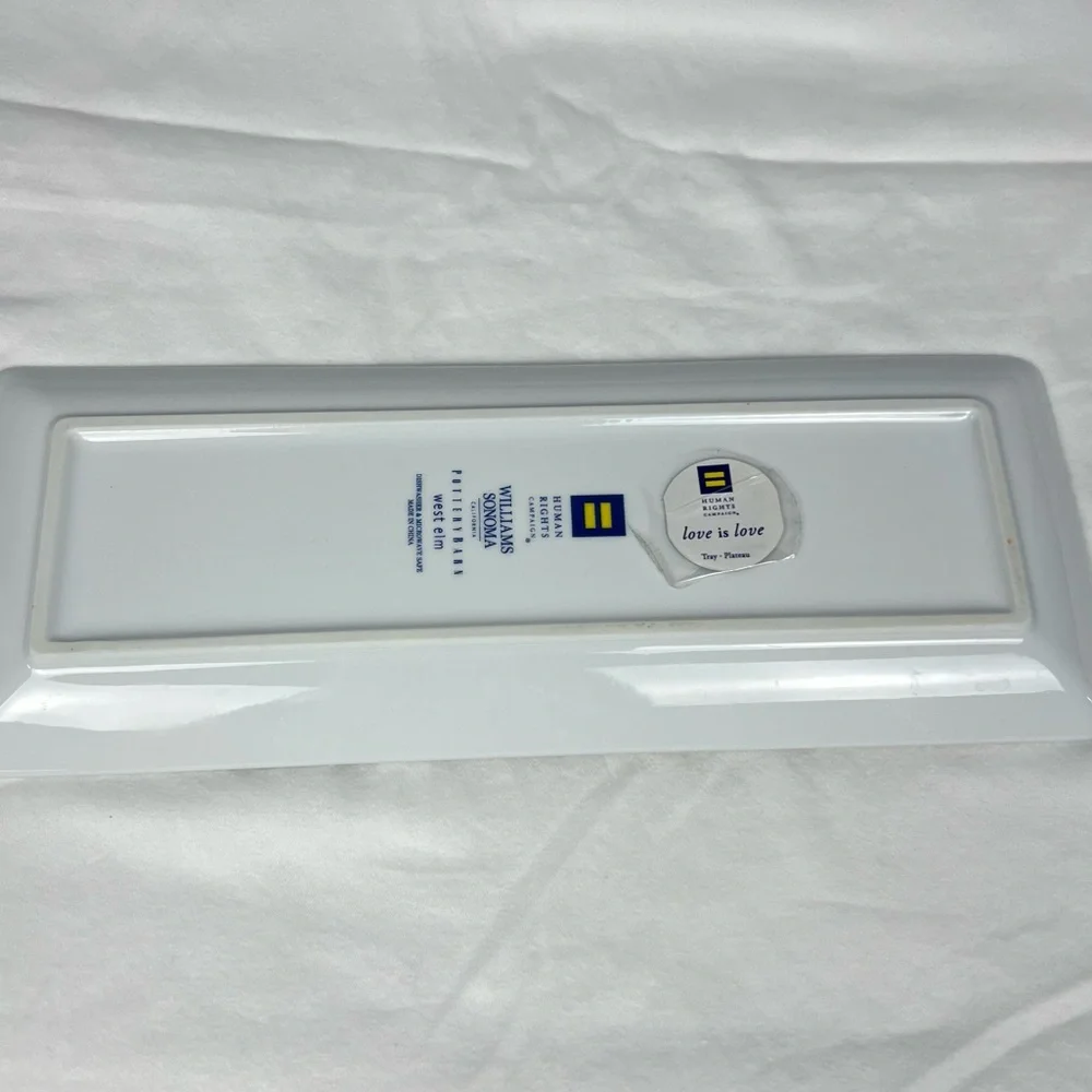 Williams Sonoma Love is Love tray with gold trim and multicolored hearts.